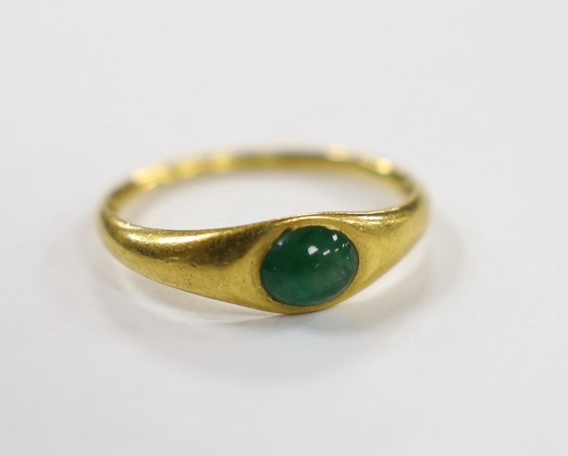 A Roman high carat yellow metal and single stone cabochon emerald set ring, size L, gross weight 3.7 grams, stone size approximately 6.9mm by 5.9mm.
